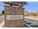 Entrance sign to the Sarah Ann Ranch community features a stacked stone facade and manicured landscaping at 12873 N 175Th Dr, Surprise, AZ 85388