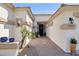 Well-lit entrance with neatly-tiled walkway to the front door, desert plants, and decorative lighting at 12873 N 175Th Dr, Surprise, AZ 85388