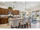 Open kitchen featuring granite counters, stainless appliances, a breakfast bar, and pendant lights at 12873 N 175Th Dr, Surprise, AZ 85388