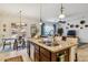 Open kitchen with granite countertops, stainless steel appliances, and an island with pendant lighting at 12873 N 175Th Dr, Surprise, AZ 85388