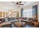 Spacious living room with a plush sectional sofa, stylish coffee table, and natural light at 12873 N 175Th Dr, Surprise, AZ 85388