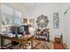 Well-lit home office featuring large desk, ample shelving, and decorative rug at 12873 N 175Th Dr, Surprise, AZ 85388