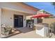 Back patio features a built in outdoor kitchen, seating area, and sliding glass door to the home at 12873 N 175Th Dr, Surprise, AZ 85388
