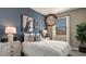 Bedroom with blue accent wall and a window with natural light at 1333 S 239Th Dr, Buckeye, AZ 85326
