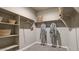 Walk-in closet with built-in shelves, hanging rods, and carpeted floor at 1333 S 239Th Dr, Buckeye, AZ 85326