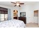 Cozy bedroom featuring ceiling fan, comfortable bedding and a view into the bathroom at 1350 S Greenfield Rd # 1016, Mesa, AZ 85206