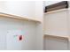 An empty walk-in closet featuring built-in shelves and wooden rods for ample storage at 1350 S Greenfield Rd # 1016, Mesa, AZ 85206