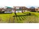 Beautiful community pool and lounging area with green grass and shade structures at 1350 S Greenfield Rd # 1016, Mesa, AZ 85206