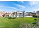 Beautiful community pool and lounging area with green grass and shade structures at 1350 S Greenfield Rd # 1016, Mesa, AZ 85206