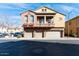 Beautiful townhome featuring three garages, a balcony, and desert landscaping at 1350 S Greenfield Rd # 1016, Mesa, AZ 85206
