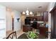 Well-lit kitchen with black appliances, a center island, and a view to a hall bathroom at 1350 S Greenfield Rd # 1016, Mesa, AZ 85206