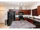Kitchen featuring black appliances, a central island, and dark cabinetry at 1350 S Greenfield Rd # 1016, Mesa, AZ 85206