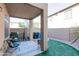 Cozy covered patio features tile flooring, an outdoor dining set, and a view of the backyard at 1350 S Greenfield Rd # 1016, Mesa, AZ 85206