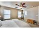 Sunny primary bedroom featuring three windows and a wooden chest at 13585 N 87Th Dr, Peoria, AZ 85381