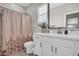 Well-lit bathroom featuring a white vanity, decorative shower curtain, and neutral wall color at 155 N Lakeview Blvd # 206, Chandler, AZ 85225