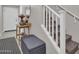Inviting home entryway featuring staircase, decorative table, and convenient storage bench at 155 N Lakeview Blvd # 206, Chandler, AZ 85225