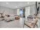 Bright living area showcasing neutral decor, comfortable seating, and outdoor balcony access at 155 N Lakeview Blvd # 206, Chandler, AZ 85225