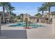 Resort-style community pool with lounge chairs, palm trees, and a clubhouse at 155 N Lakeview Blvd # 206, Chandler, AZ 85225