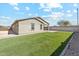 Relaxing backyard with artificial grass, a patio, and privacy walls, making it ideal for outdoor enjoyment at 18153 W Fulton St, Goodyear, AZ 85338
