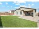 A relaxing backyard featuring well-kept turf, a brick patio, and privacy walls for outdoor gatherings at 18153 W Fulton St, Goodyear, AZ 85338
