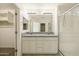 Bright bathroom with granite counters, dual sinks, walk-in shower, and a convenient storage area at 18153 W Fulton St, Goodyear, AZ 85338