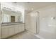 Bright bathroom with double vanity, granite counters, and a modern shower at 18153 W Fulton St, Goodyear, AZ 85338