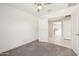 Cozy bedroom featuring carpet floors, a ceiling fan, and neutral paint at 18153 W Fulton St, Goodyear, AZ 85338