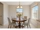 Charming dining area with a round table, seating for four, and natural light from the windows at 18153 W Fulton St, Goodyear, AZ 85338