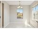 Bright dining area with light tile floor and a charming window at 18153 W Fulton St, Goodyear, AZ 85338