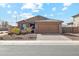 Charming single-story home with well-manicured landscaping and a two-car garage at 18153 W Fulton St, Goodyear, AZ 85338