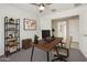 Functional home office featuring a work desk, shelving, and a comfortable chair at 18153 W Fulton St, Goodyear, AZ 85338