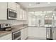 Modern kitchen featuring stainless steel appliances and granite countertops at 18153 W Fulton St, Goodyear, AZ 85338