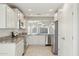 Bright and modern kitchen featuring white cabinetry, granite counters and stainless steel appliances at 18153 W Fulton St, Goodyear, AZ 85338