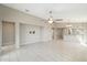 Open-concept living area with tile flooring, neutral paint, and a wall-mount TV setup at 18153 W Fulton St, Goodyear, AZ 85338
