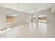 Spacious living room with tile floors, neutral walls, ceiling fan, and sliding glass door to the yard at 18153 W Fulton St, Goodyear, AZ 85338