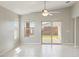 Bright living room featuring tile floors, neutral walls and a sliding glass door to the backyard at 18153 W Fulton St, Goodyear, AZ 85338