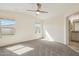 Spacious main bedroom with carpet floors, natural light, and a ceiling fan at 18153 W Fulton St, Goodyear, AZ 85338