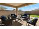 Inviting outdoor patio area with comfortable seating and a well-manicured lawn at 18153 W Fulton St, Goodyear, AZ 85338