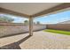 Covered patio featuring a stone-paved floor and privacy walls offering comfort for outdoor relaxation at 18153 W Fulton St, Goodyear, AZ 85338