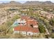 Expansive estate with a pool, covered patio, tennis courts, mature trees, and scenic mountain backdrop at 19494 N 98Th Pl, Scottsdale, AZ 85255