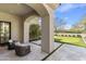 Covered back patio with comfortable seating and scenic putting green views, perfect for relaxing and enjoying the outdoors at 19494 N 98Th Pl, Scottsdale, AZ 85255