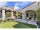 Scenic backyard with lush putting green, manicured landscaping, and stone tile patio, perfect for entertaining at 19494 N 98Th Pl, Scottsdale, AZ 85255