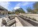 Backyard features a large pool and spa, modern lounge chairs and a linear fireplace at 19494 N 98Th Pl, Scottsdale, AZ 85255