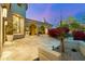 An expansive backyard with low block wall, blooming bougainvillea, and an arched exterior entryway at 19494 N 98Th Pl, Scottsdale, AZ 85255