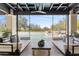 Covered outdoor space with hanging swing beds overlooking a pristine swimming pool and landscaped yard at 19494 N 98Th Pl, Scottsdale, AZ 85255