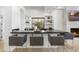 Stylish bar area featuring dark countertops, seating for three, modern shelving, and a beverage cooler at 19494 N 98Th Pl, Scottsdale, AZ 85255