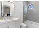 Bright bathroom featuring a modern vanity with a framed mirror, sleek fixtures, and a shower-tub combo at 19494 N 98Th Pl, Scottsdale, AZ 85255