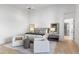 Bright primary bedroom with accent wall and a comfortable sitting area at 19494 N 98Th Pl, Scottsdale, AZ 85255