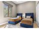 Cozy bedroom with two twin beds, a large window, and stylish decor creating a comfortable and inviting space at 19494 N 98Th Pl, Scottsdale, AZ 85255
