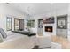Primary bedroom with a fireplace, TV and a view to the backyard at 19494 N 98Th Pl, Scottsdale, AZ 85255
